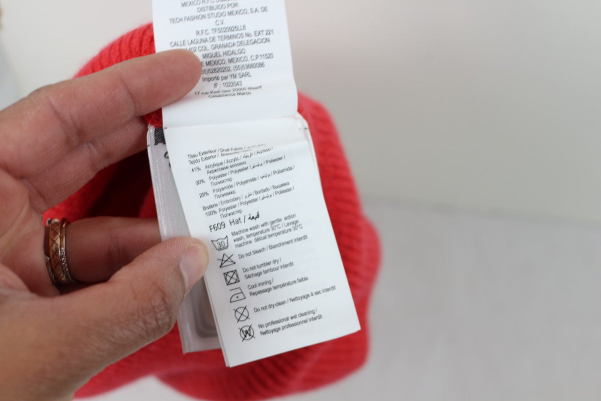 Étiquette de composition et d'entretien du bonnet Camaïeu corail – Frippin'Dealz