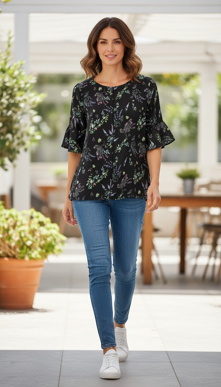 Frippindealz black polyester blouse with a delicate floral print and flutter sleeves.