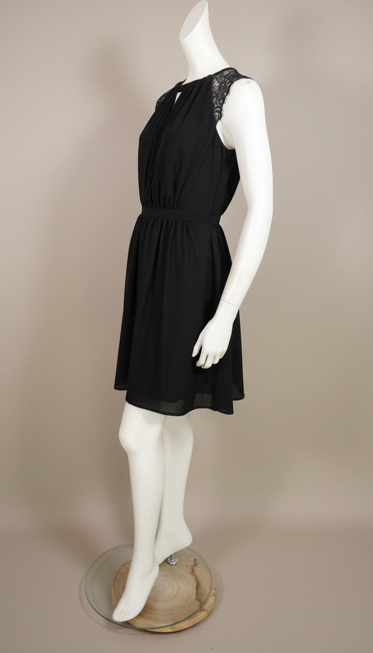 Frippindealz black polyester short dress with lace cap sleeves and keyhole neckline. Elasticated waist.