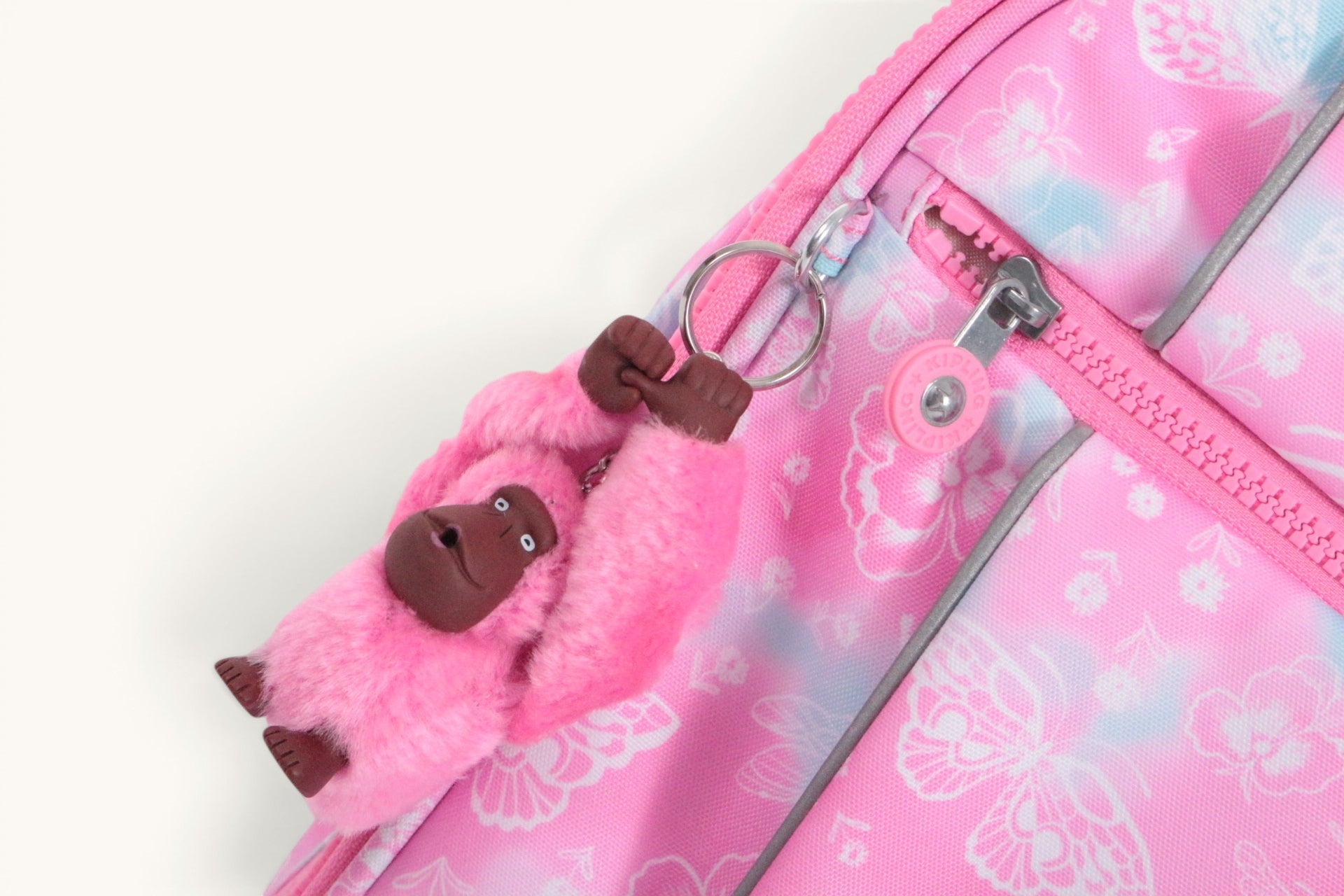 Cartable Kipling New Storia rose à motifs fleurs et papillons avec porte-clés singe Frippindealz