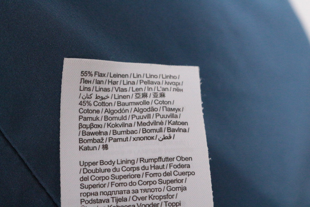 Étiquette de composition textile Frippindealz indiquant 55% lin et 45% coton pour un manteau EDC bleu