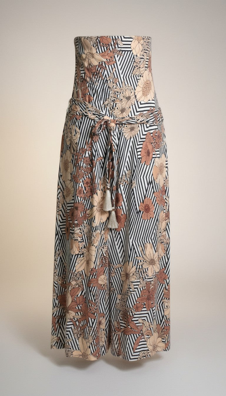 Frippindealz long polyester dress with floral print in beige and brown on a black and white striped background, featuring a tie waist and tassels.