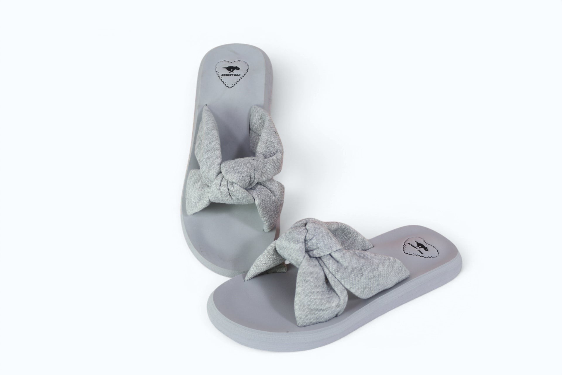 Mules Frippindealz Rocket Dog pour femme en textile gris chiné avec un large nœud décoratif, style estival décontracté