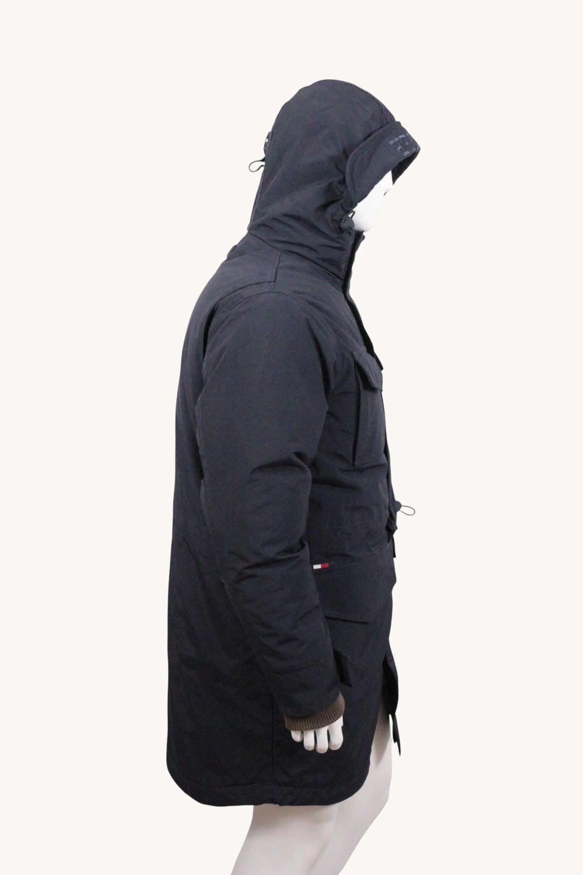 Parka Frippindealz Tommy Hilfiger bleu marine avec capuche et poches, vue de profil sur mannequin