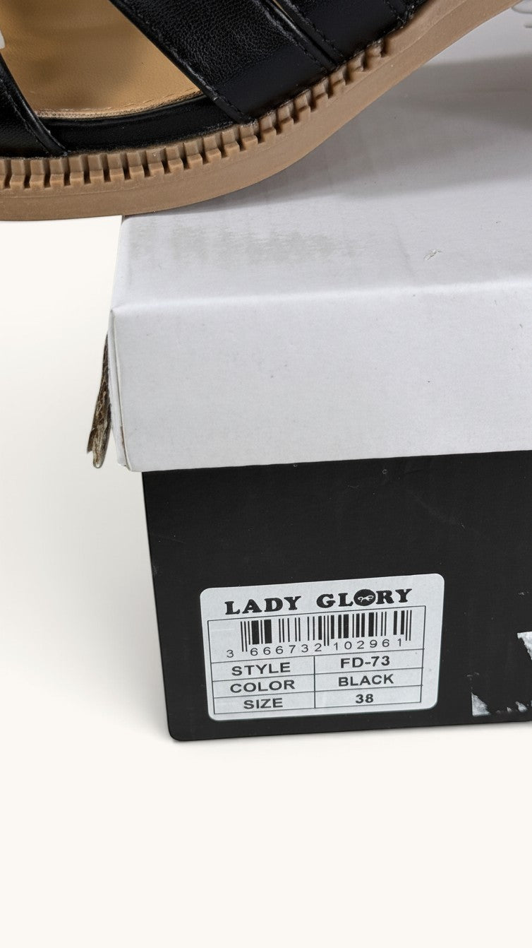 Sandales Frippindealz Lady Glory noires en cuir synthétique avec talon bloc et semelle aspect bois sur leur boîte