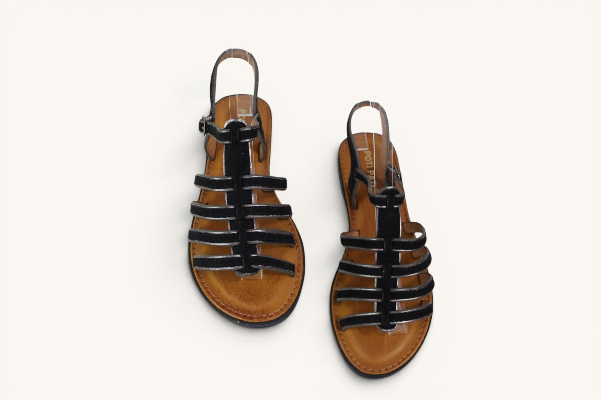 Sandales romaines Frippindealz Poti Pati noires à brides multiples et semelle plate marron