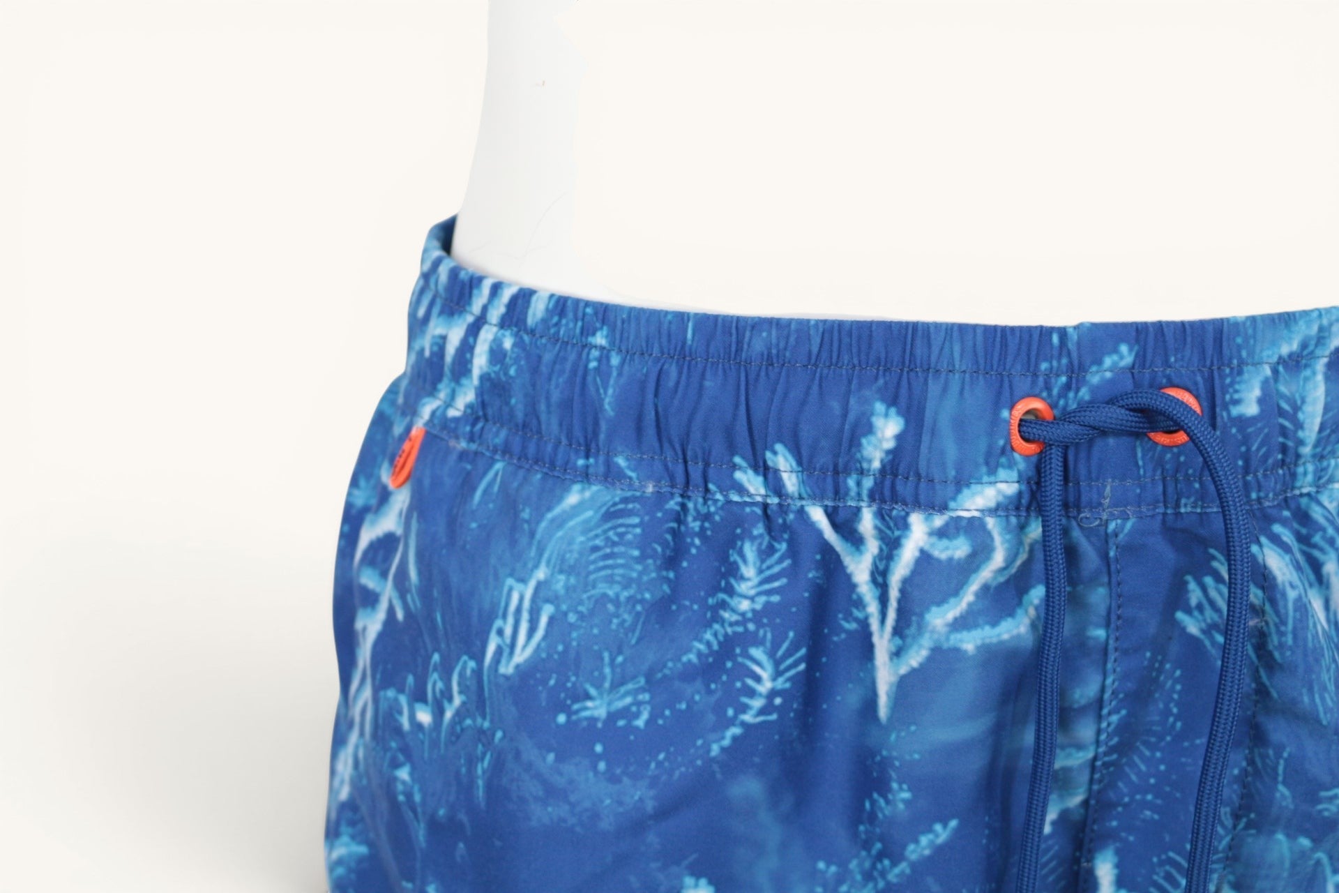 Short de bain Frippindealz Petrol Industries bleu à motif coraux, taille élastique et cordon de serrage orange.