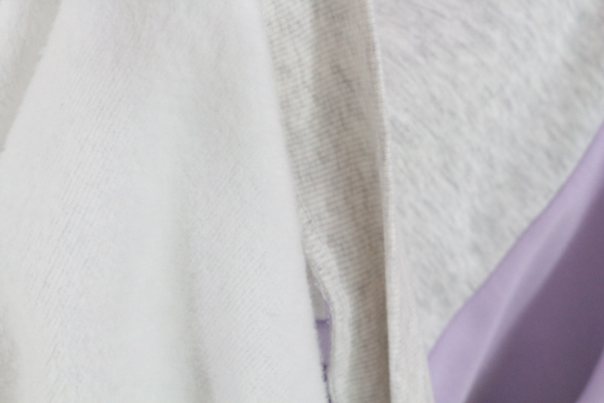 Gros plan sur la doublure douce et molletonnée du sweat-shirt Frippindealz gris et lavande