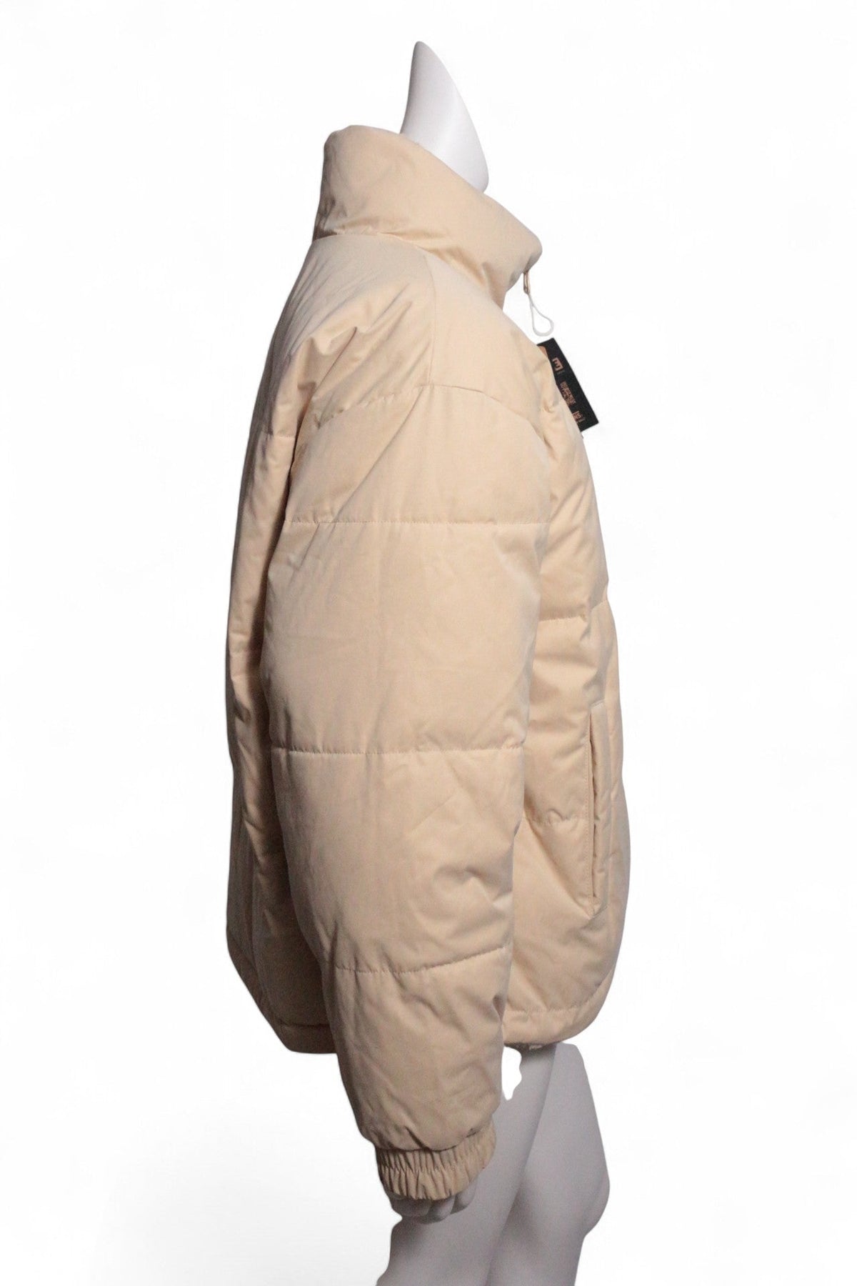 Doudoune réversible Frippindealz Van's en polyester beige, coupe matelassée avec col montant, vue de profil.