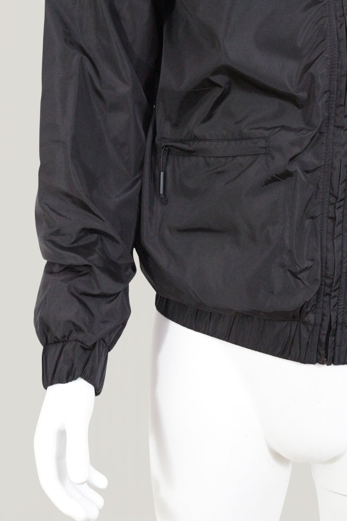 Veste imperméable noire Frippindealz avec fermeture éclair et poches latérales sur mannequin