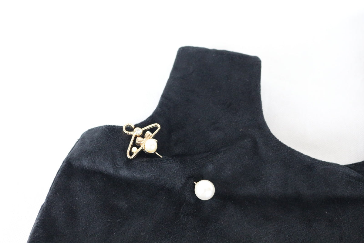 Détail du tissu velours noir et des deux accessoires perle et épingle dorée sur le sac Naf Naf – Frippin'Dealz